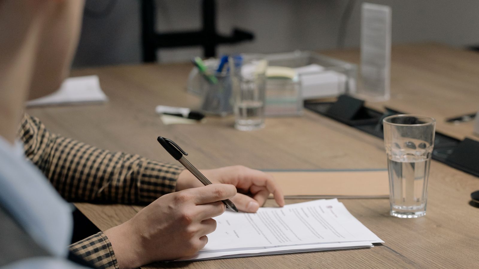 Signing an official registration document at a desk